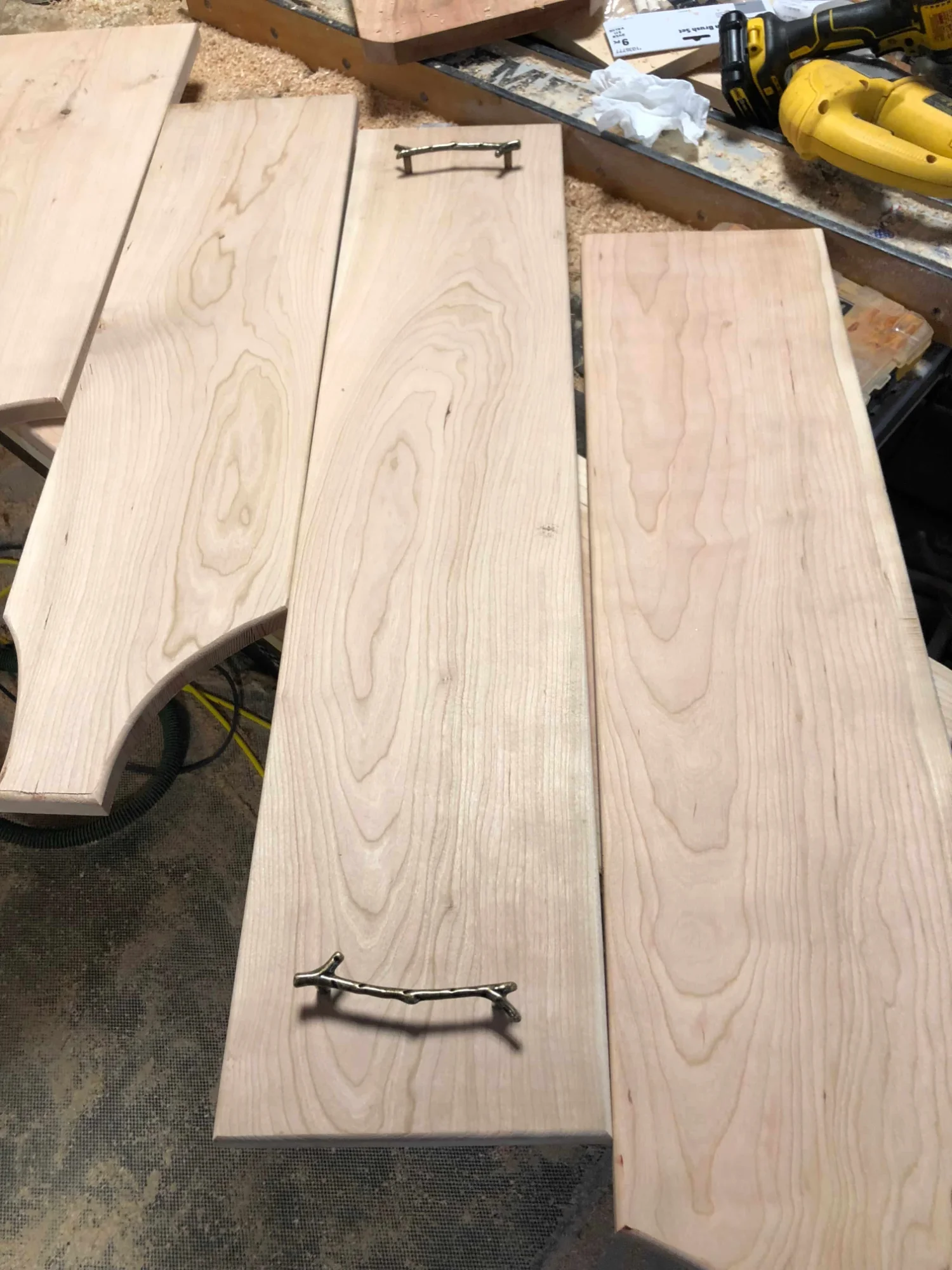 Handmade charcuterie boards with twig handles in progress